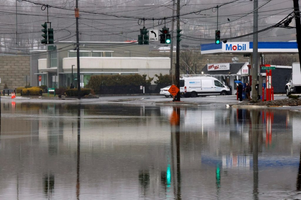 Storms wallop the Northeast, ground flights, flood roads