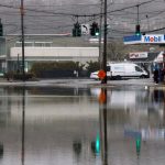 Storms wallop the Northeast, ground flights, flood roads