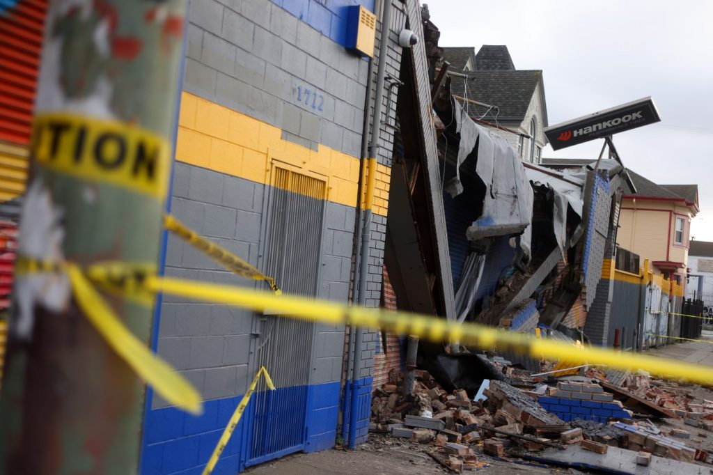 Oakland auto body shop heavily damaged after vehicle crashes into it