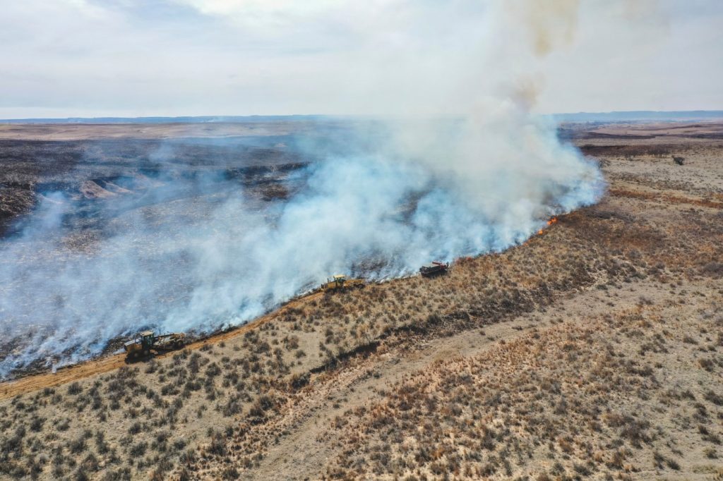 Firefighters face difficult weather conditions as they battle the largest wildfire in Texas history