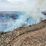 Firefighters face difficult weather conditions as they battle the largest wildfire in Texas history