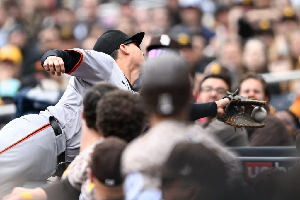 Wilmer Flores leaves SF Giants game after tumbling over dugout railing