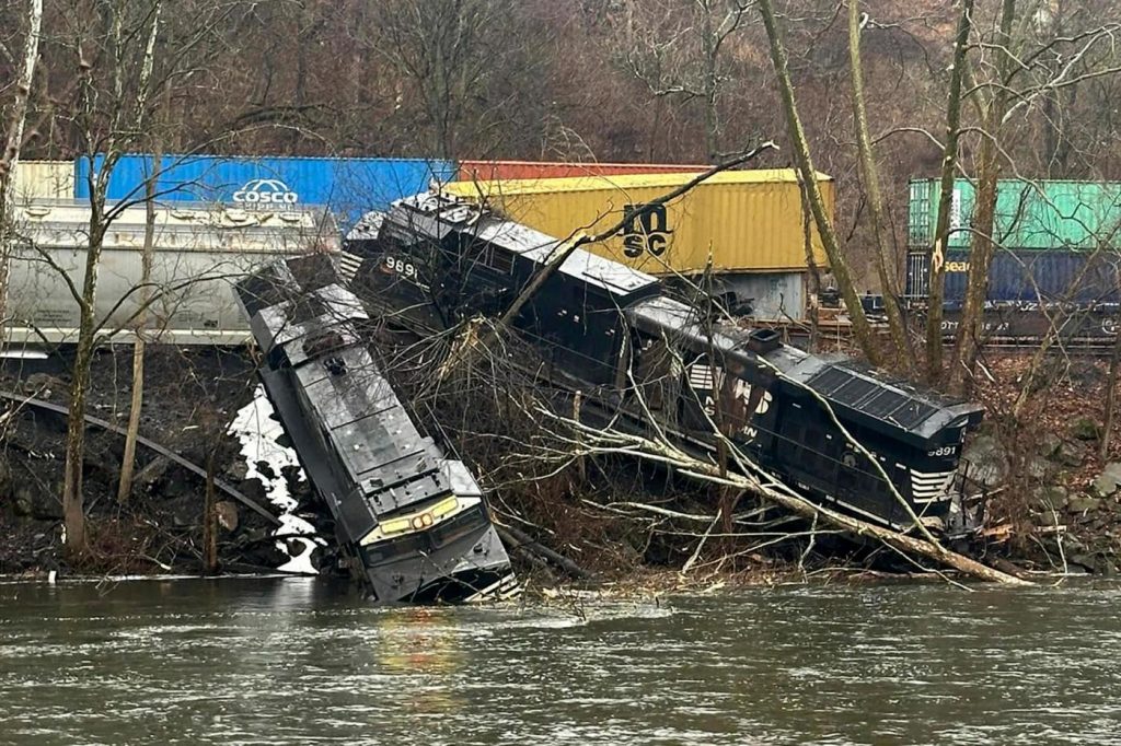 Train derailment leaves cars on riverbank or in water; no injuries, hazardous materials reported