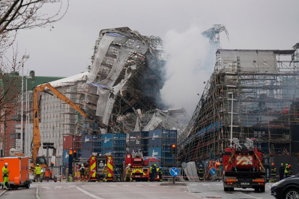 Firefighters work carefully around remains of Copenhagen landmark