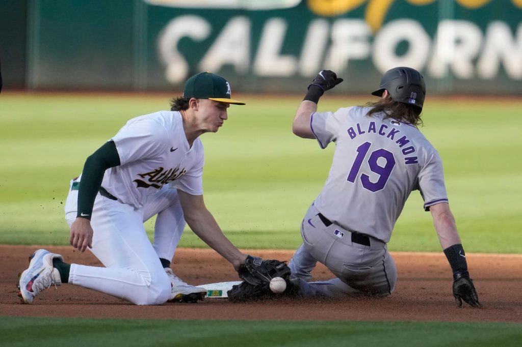 A’s come back to force extras but fall to Rockies