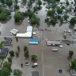 Helicopters scramble to rescue people in flooded Iowa town while much of US toils again in heat