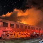 Three-alarm fire torches West Oakland roofing supply business