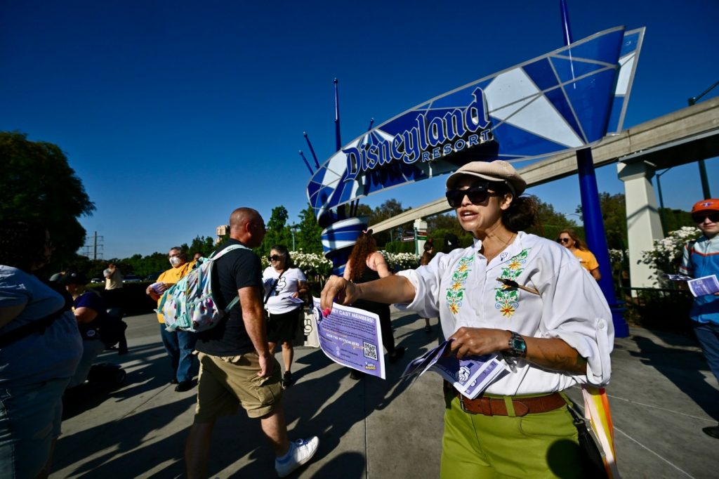 Disneyland union hands out Mickey Mouse raised fist buttons to theme park visitors