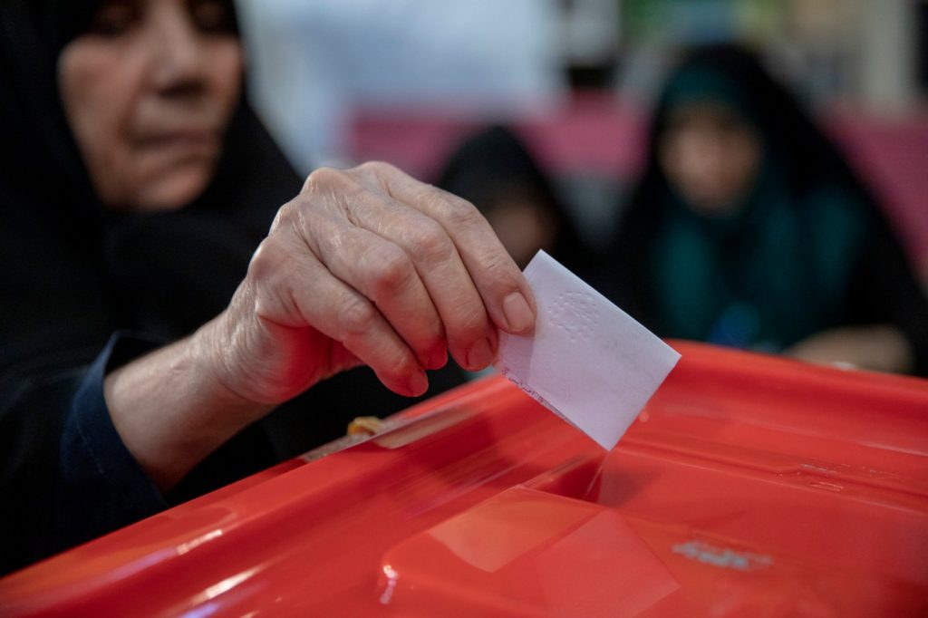 Reformer vs. hard-liner as Iran votes in presidential runoff