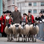 Damian Lewis herds sheep over a London bridge as part of a quirky tradition